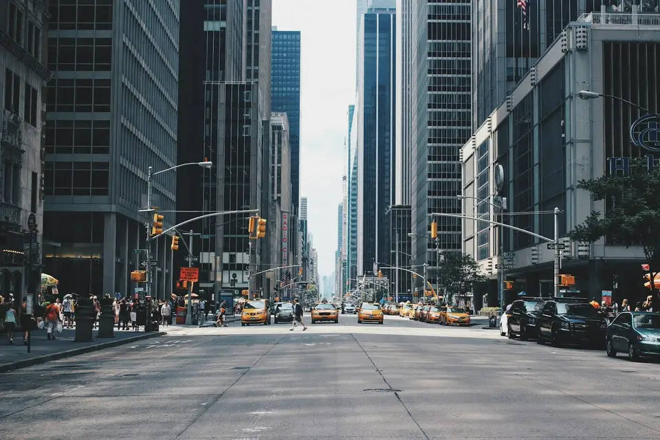Well-lit city street after dark — the kind of arrival you can plan for